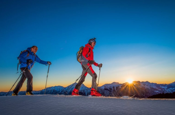 difference between ski touring and cross country skiing